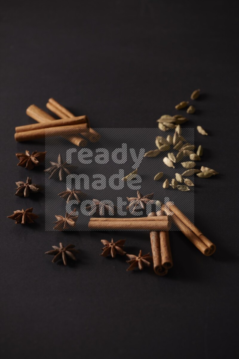 Cinnamon Sticks, Cardamom and star anise on a black background