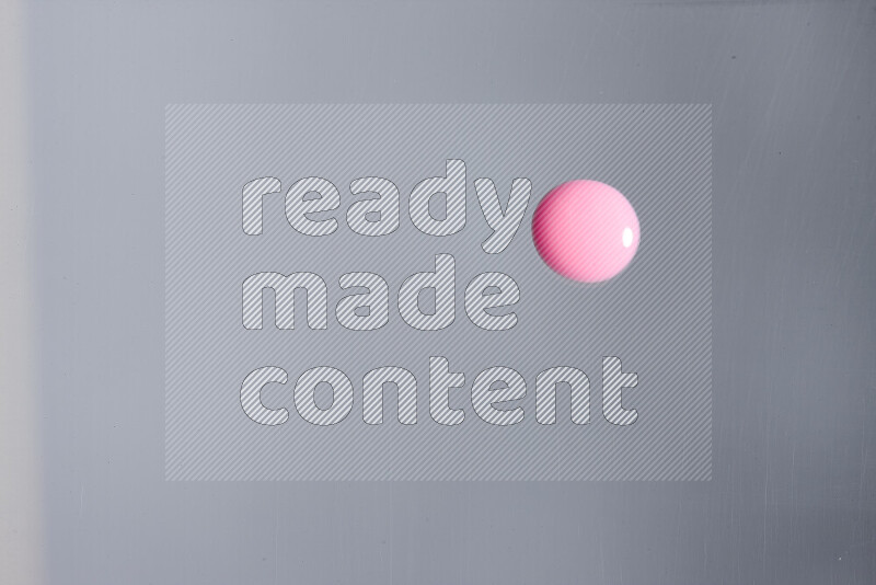 Close-ups of abstract pink paint droplets on the surface