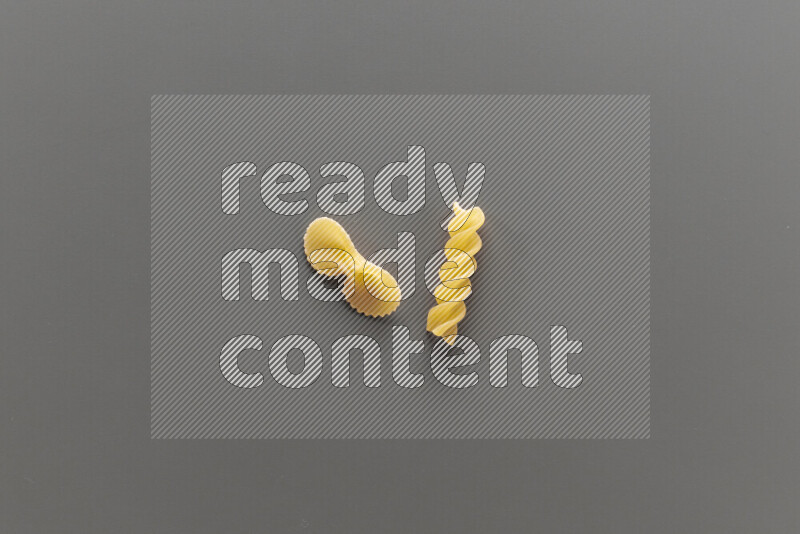 Fiocchi pasta with other types of pasta on grey background