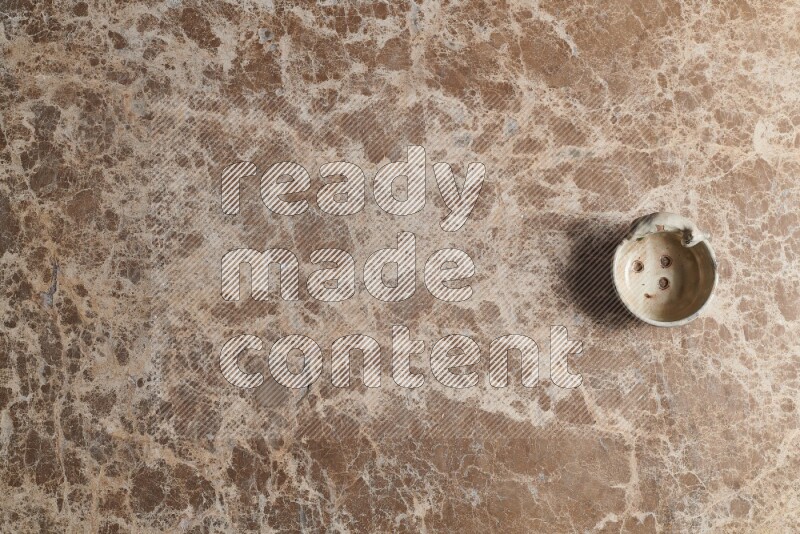 A pottery soap holder on beige marble background