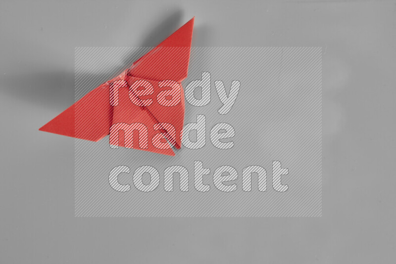 Origami butterfly on grey background