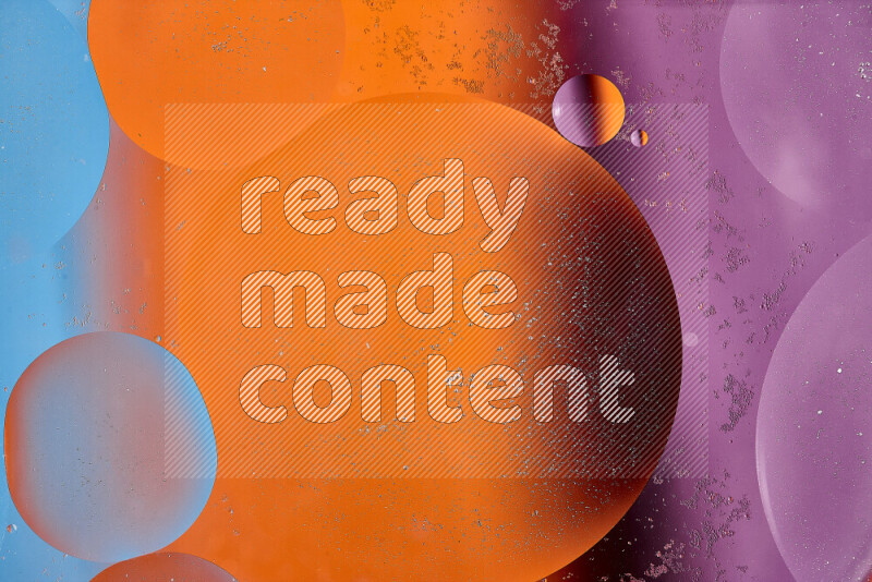 Close-ups of abstract oil bubbles on water surface in shades of blue, orange and purple