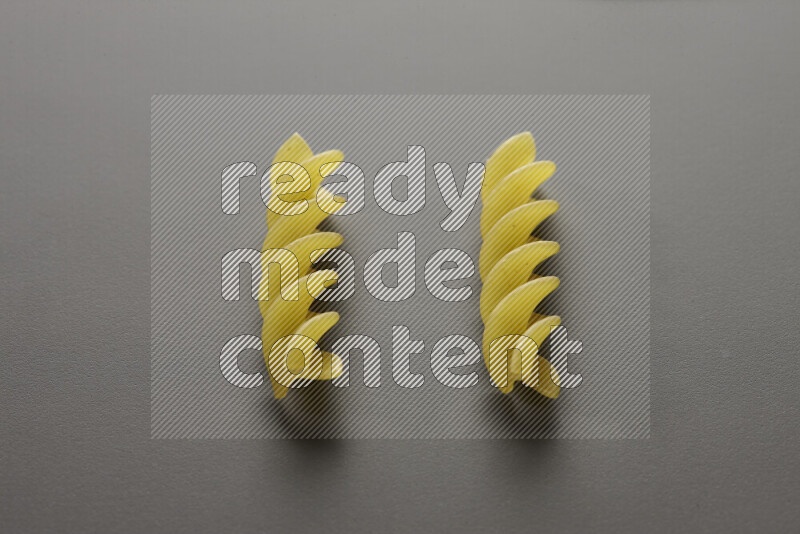Fusilli pasta on grey background