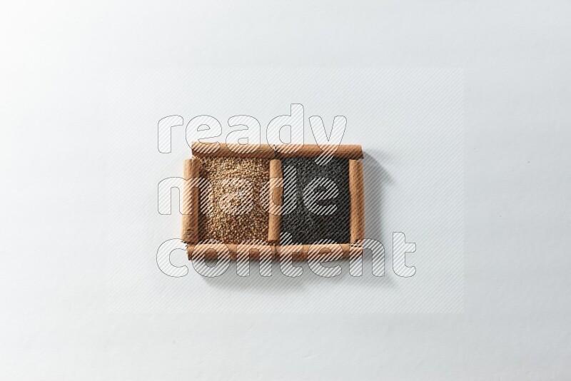 2 squares of cinnamon sticks full of mustard seeds and black seeds on white flooring