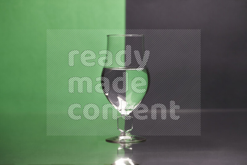 The image features a clear glassware filled with water, set against green and black background