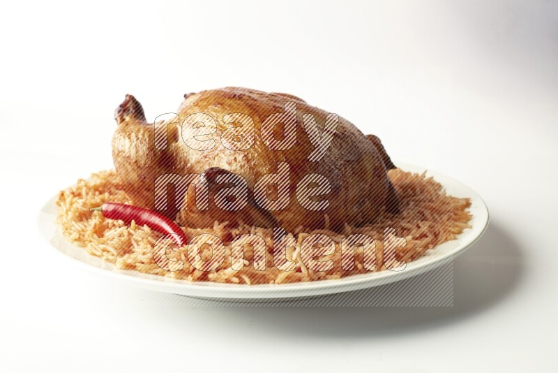 red basmati Rice with  whole roasted chicken on a white rounded plate  direct  on white background