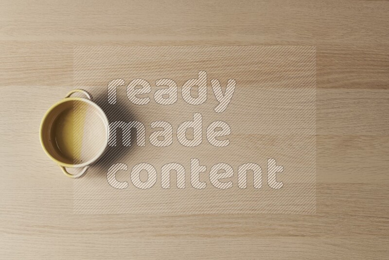 A multicolored pottery oven plate on light wooden background