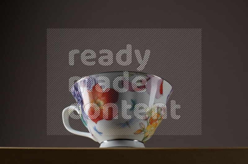Low angle shot of a decorated cup on grey background