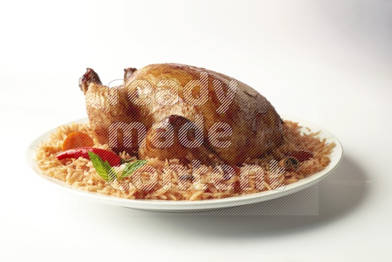red basmati Rice with  whole roasted chicken on a white rounded plate  direct  on white background