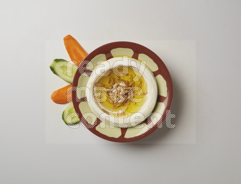 Lebnah garnished with pine nuts in a traditional plate on a white background