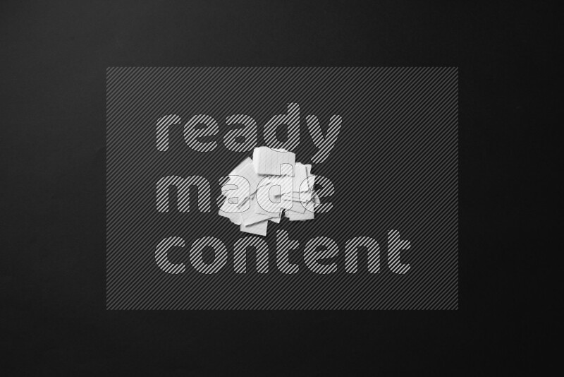 Ripped notebook sheet on black background