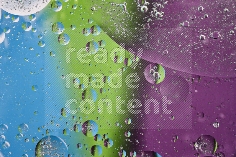 Close-ups of abstract oil bubbles on water surface in shades of purple, green and blue
