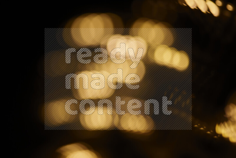 Light bulbs glowing against backdrop of golden bokeh