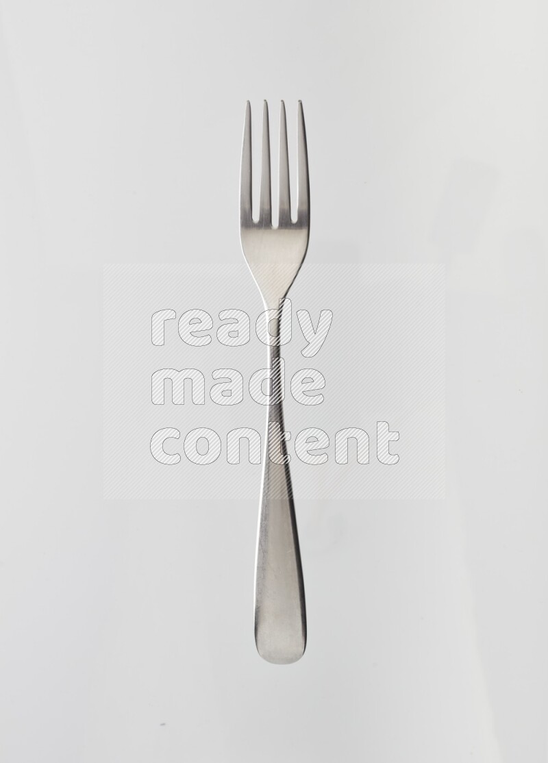 Silver stainless steel fork on white background