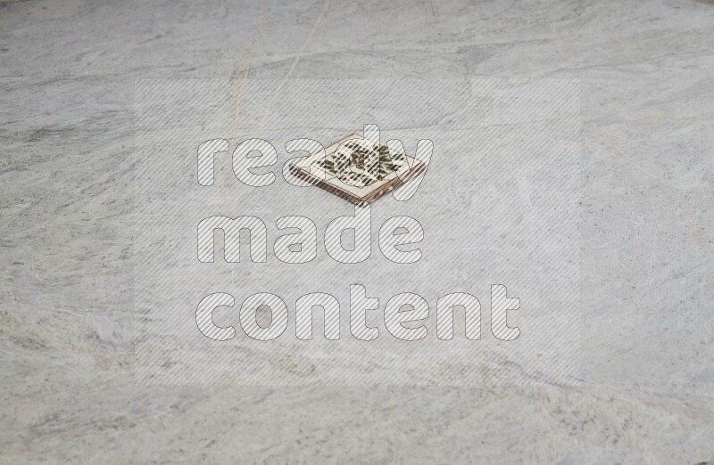 Top view shot of a pottery coaster\ tile on beige marble flooring