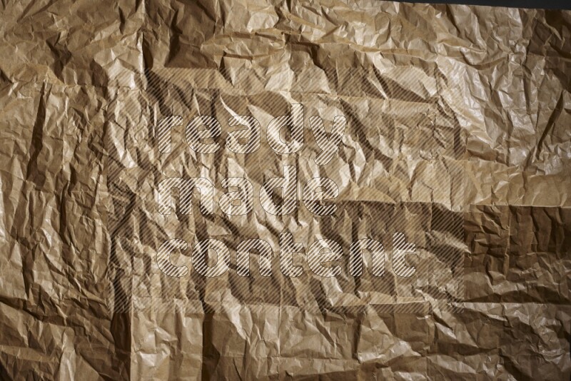 Crumpled craft paper on black background