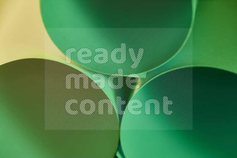 The image shows an abstract paper art with circular shapes in varying shades of green and warm tones