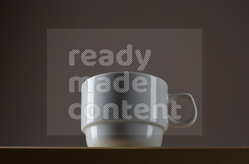 Low angle shot of a white cup on grey background