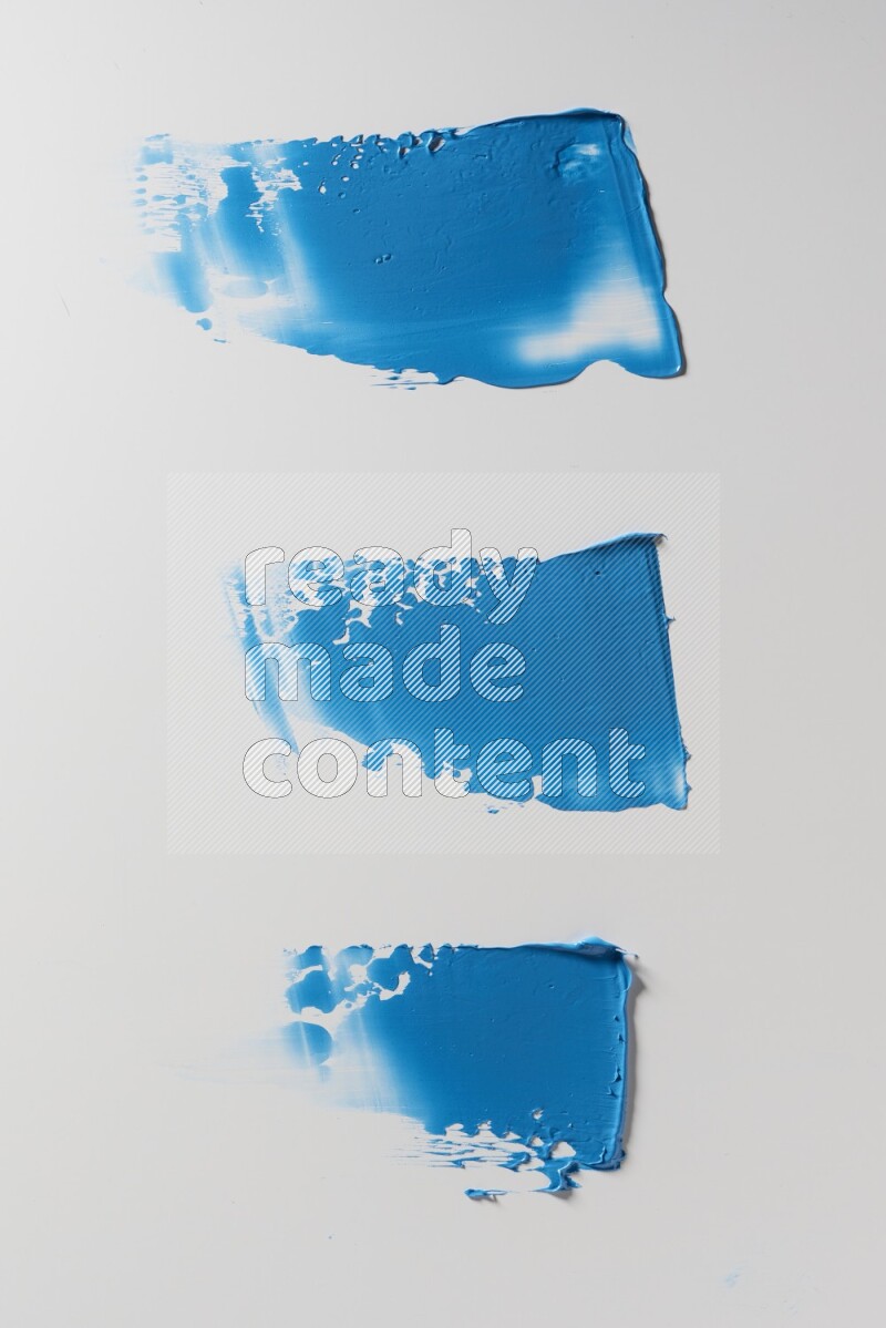 Blue painting knife strokes on a white background