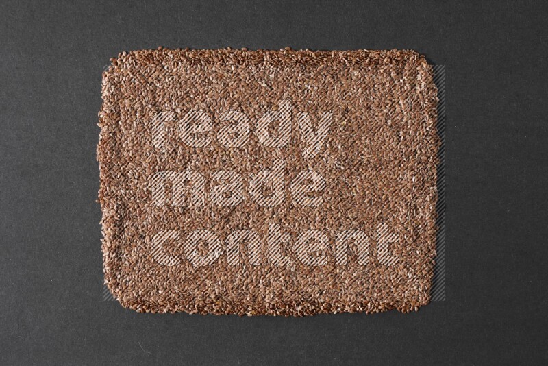 Flaxseeds Filling the Frame on a black Flooring