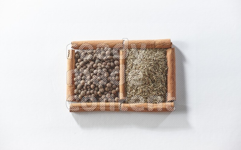 2 squares of cinnamon sticks full of allspice and cumin on white flooring