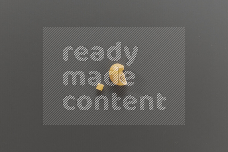 Small rings pasta with other types of pasta on grey background