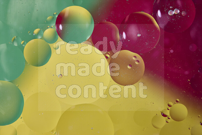 Close-ups of abstract oil bubbles on water surface in shades of yellow, red and green