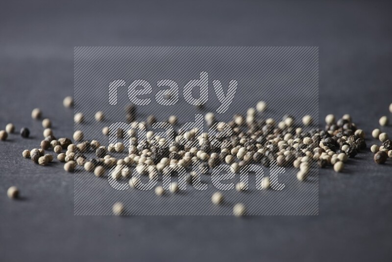 Mixed black and white pepper beads on a black flooring