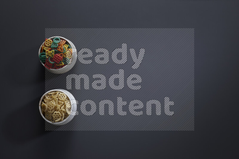 Legumes in pottery bowls on grey background
