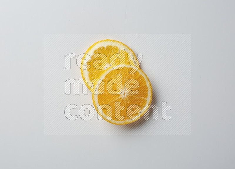 Two orange slices on white background