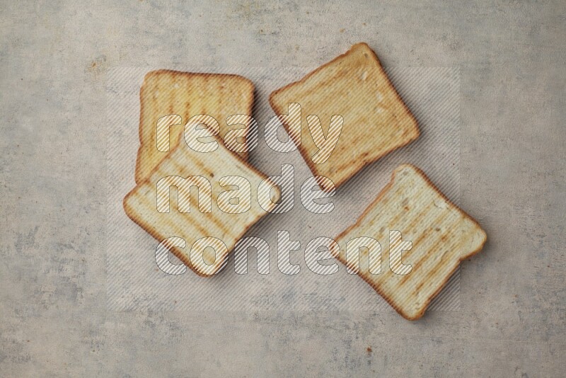 Toasted white Toast slices on a light blue textured background