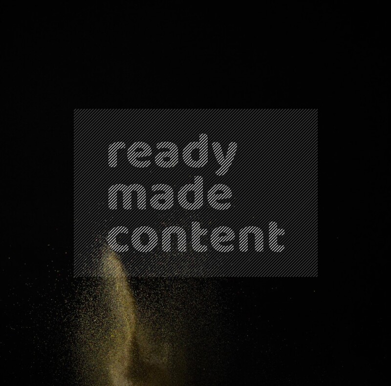 A side view of brown powder explosion on black background