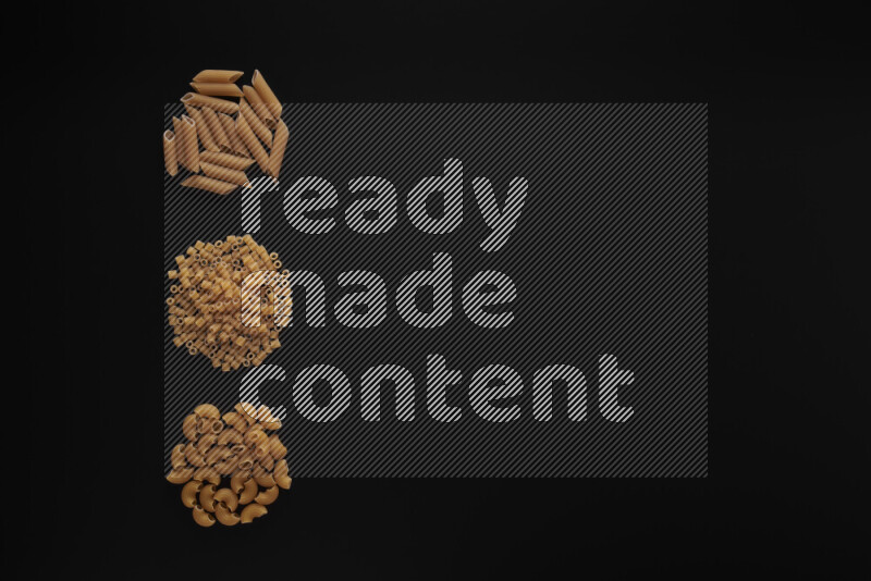 Different pasta types in 3 bunches on black background