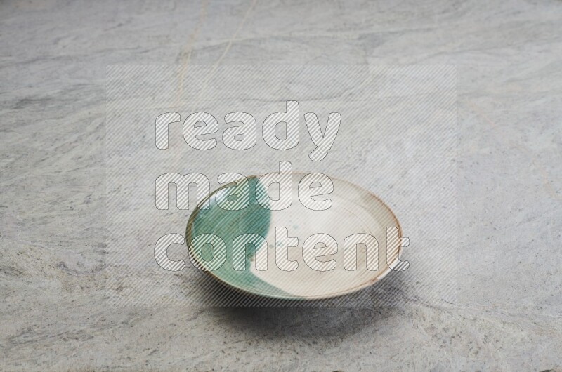 Decorative Pottery Plate On Grey Marble Flooring