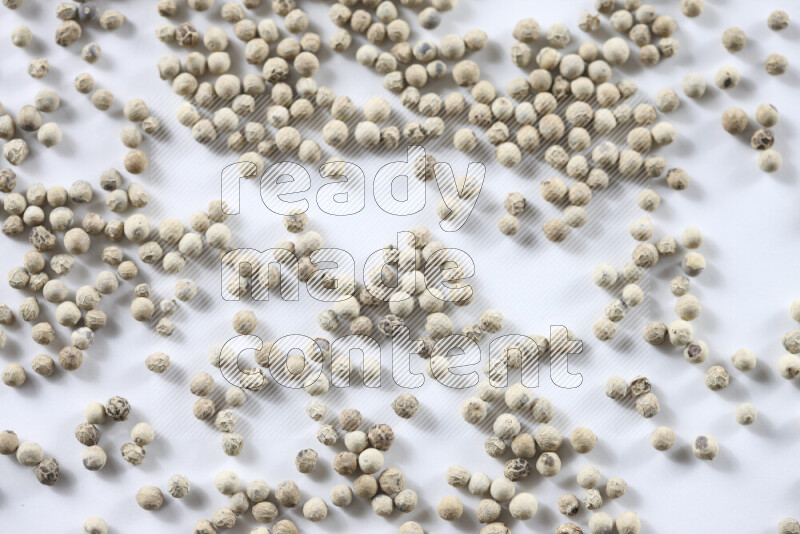White pepper beads on white background