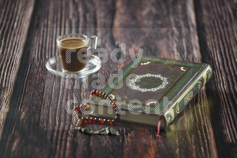 Quran with dates, prayer beads and different drinks all placed on wooden background
