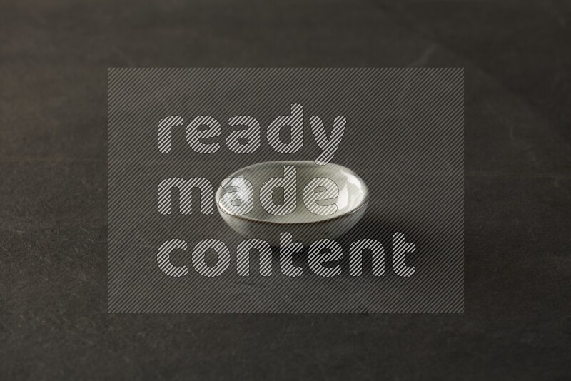 multi color round sauce bowl on grey textured countertop