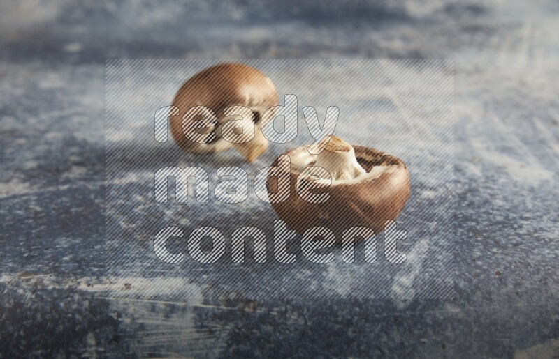 45 degre cremini  mushrooms on a textured rustic blue background
