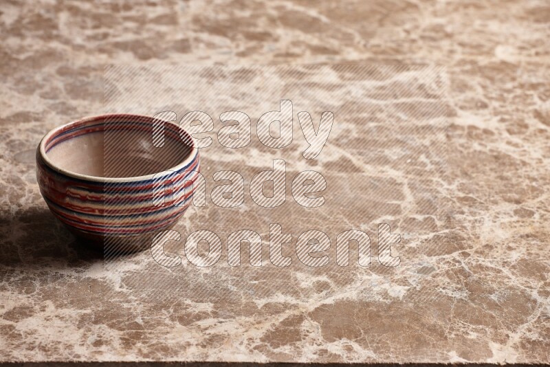 Multicolored Pottery Bowl on Beige Marble Flooring