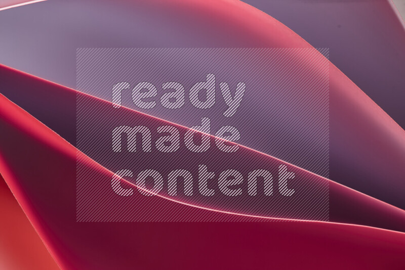 هذه الصورة تعرض تكوين فن الورق التجريدي مع منحنيات ورقية بتدرجات لونية دافئة مختلفة المكونه بواسطة الضوء الملون