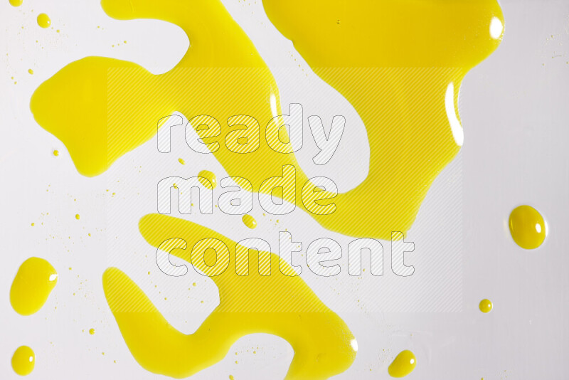 Close-ups of abstract yellow paint droplets on white background