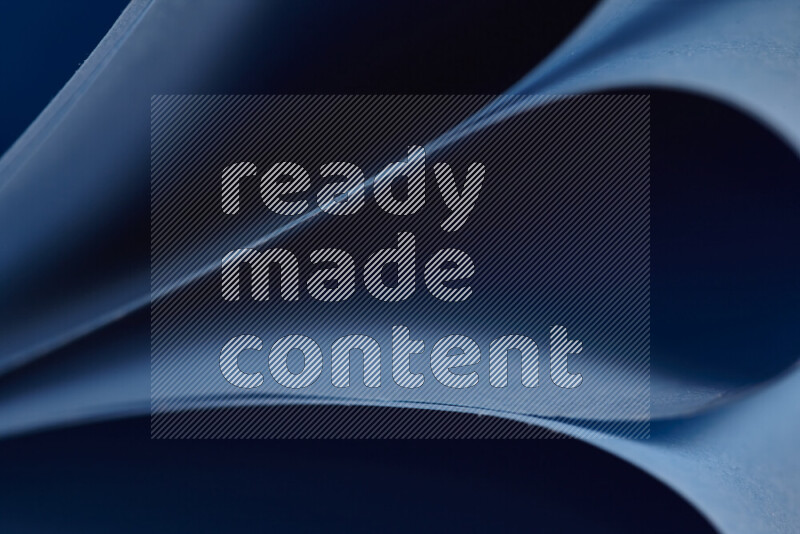 An abstract art showing blue paper sheets arranged in an overlapping curves