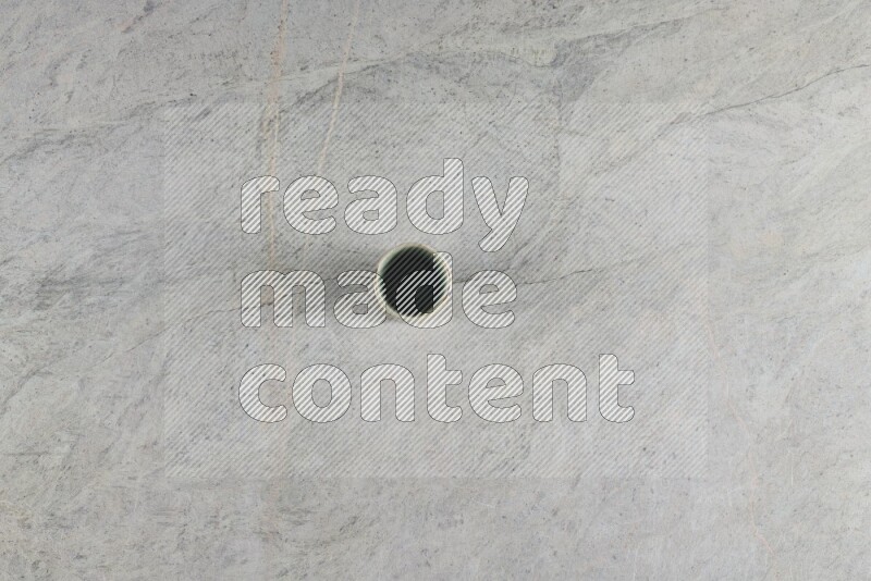 A multicolored pottery Cup on grey marble background