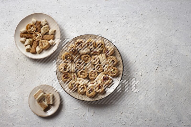 Oriental sweets in pottery plates in a light setup