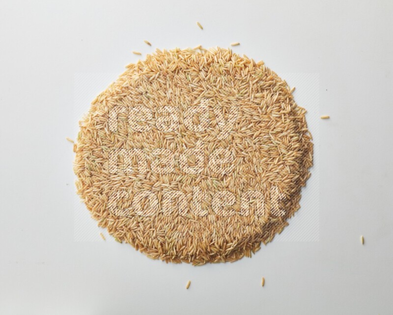Top-view shot of long grain brown rice on white background