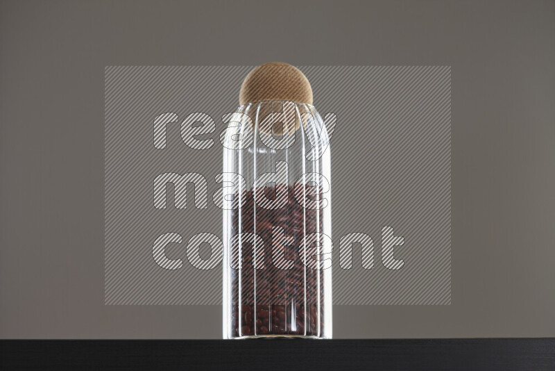 فاصوليا حمراء في وعاء زجاجي على خلفية سوداء