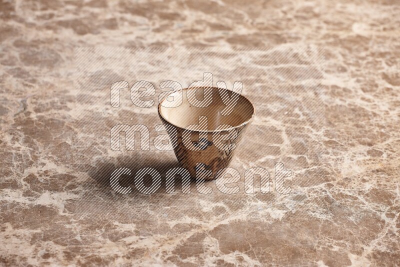 A decorative pottery bowl on beige marble background