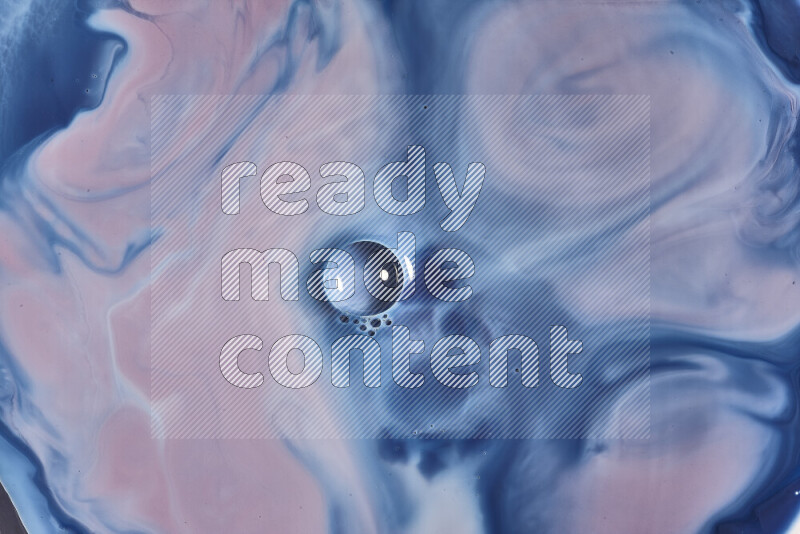 A close-up of abstract swirling patterns in blue, red and white