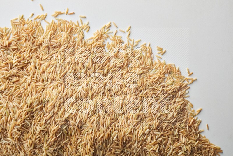 Long grain brown rice on white background