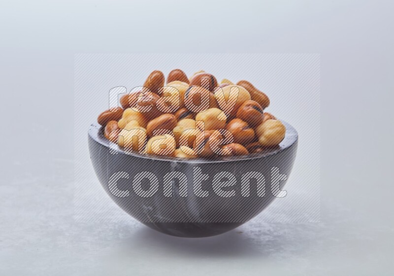 Close up shot of cooked fava beans (foul) & chickpeas on white background